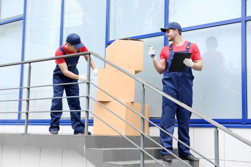 Professional movers loading items into a removals van