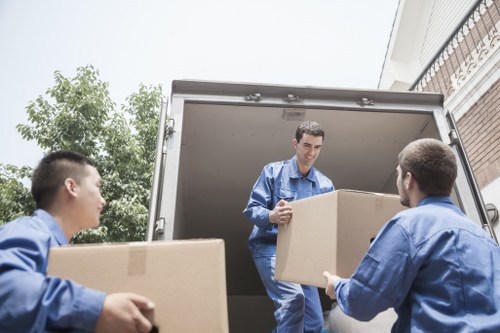 Furniture removal team handling bulky items in a Crayford home