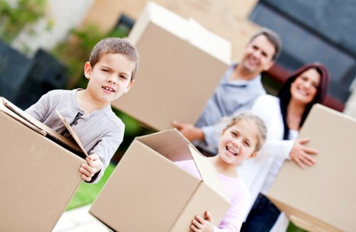 Boxes and packed belongings being arranged for unpacking in Crayford